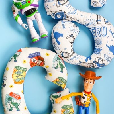 The Buzz Lightyear and Woody characters from Toy Story with alphabet stuffies make by the Cricut Maker