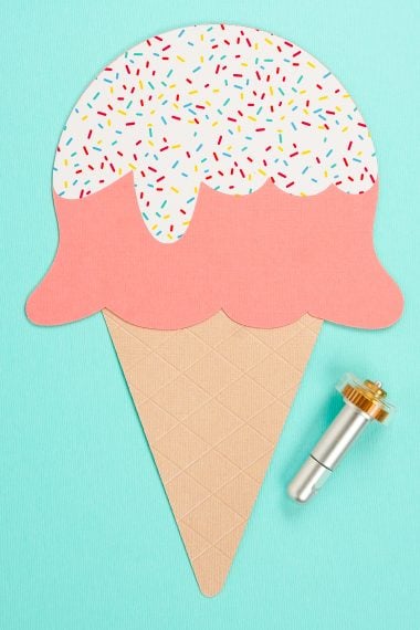 Image of the Cricut Maker Debossing Tool next to a cutout of an ice cream cone with two scoops of ice cream and sprinkles