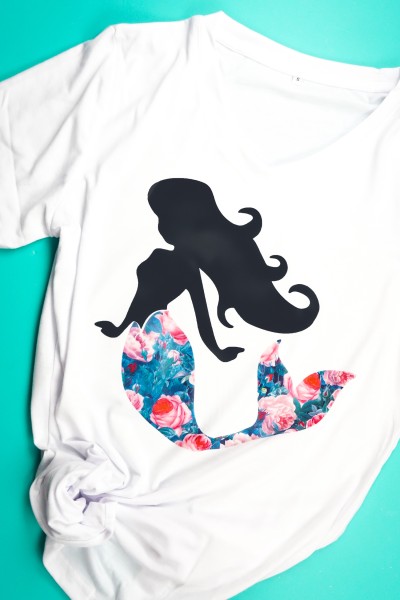 A white t-shirt with an image of a mermaid on it