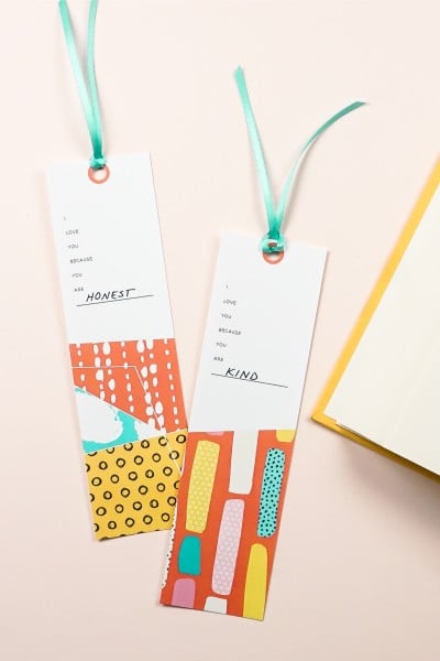 Two fill-in-the-blanks printable bookmarks alongside of an open book