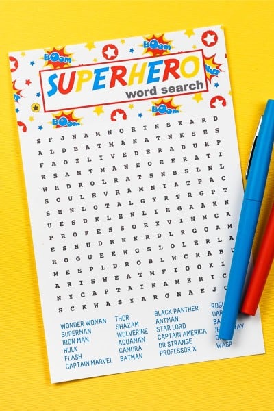 A Superhero Word Search page with a blue and red marker laying against a yellow background