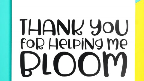An image of a clipboard decorated with flowers and the saying, "Thanks you for Helping Me Bloom"