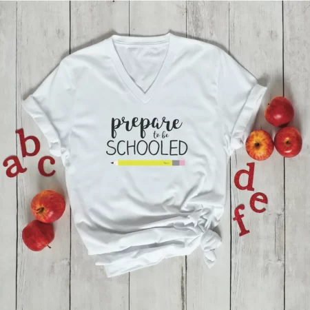 White t-shirt decorated with a pencil and the saying “Prepare to be schooled!”