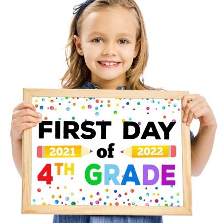 Girl holding colorful back to school sign