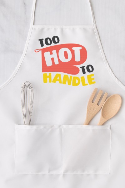 A kitchen apron with a whisk in one pocket and a wooden fork and spoon in the other pocket.  Apron has a design on it of a red oven mitt and the words "Too Hot to Handle" on it