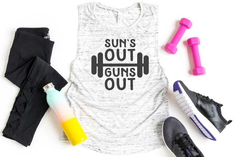 Workout pants, water bottle, tennis shoes, weightlifters and a tank top shirt with the saying \"Sun\'s Out Guns Out\"