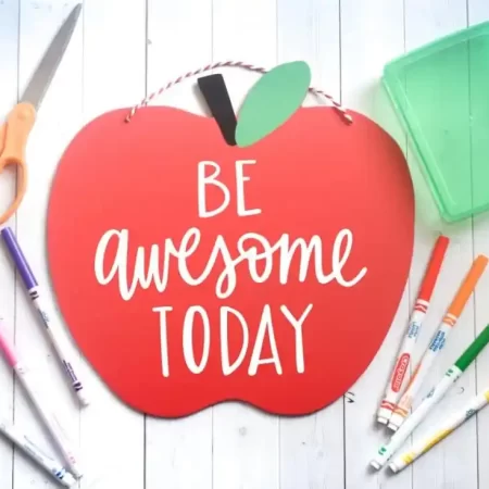 Red apple sign with a hand lettered SVG that says “Be Awesome Today”