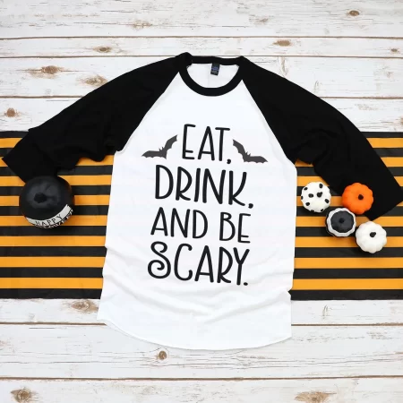 Black and white baseball style t-shirt with two bats on it and the saying Eat, Drink, and Be Scary