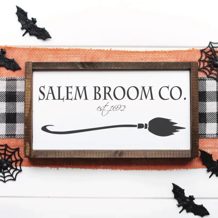 Wooden frame on a sign that says Salem Broom Co