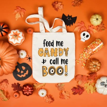 White tote bag with the saying Feed Me Candy and Call Me Boo