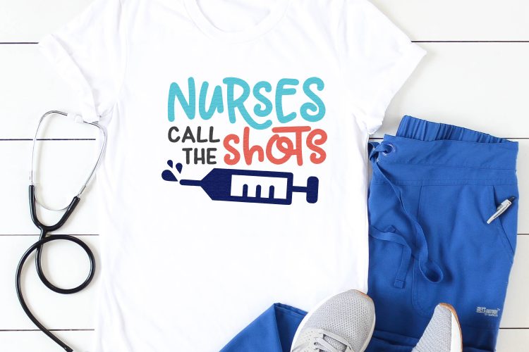 Blue hospital scrubs, tennis shoes, a stethoscope and a white t-shirt with the design of a syringe on it and the saying, \"Nurses Call the Shots\" 