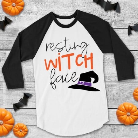 White and black baseball style shirt with a witches hat on it and the saying Resting Witch Face