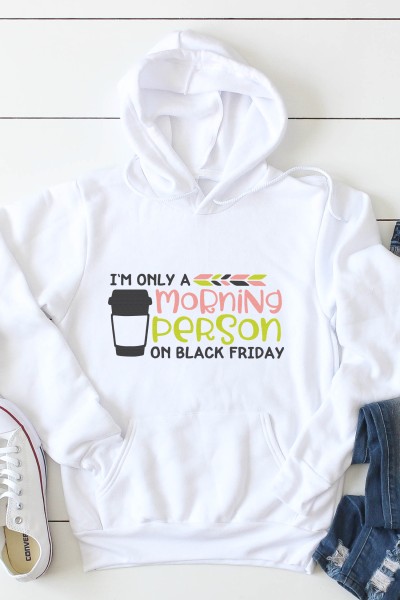 A pair of blue jeans, tennis shoes and a white hooded sweatshirt that is decorated with a coffee tumbler and a saying that says, "I'm Only a Morning Person on Black Friday"