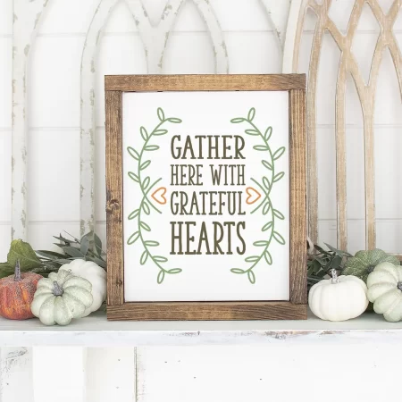 Framed white sign that says Gather Here with Grateful Hearts
