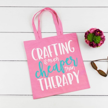 Pink tote bag with the saying Crafting is Much Cheaper Than Therapy