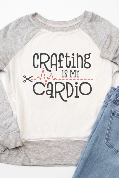 Blue jeans and a sweatshirt with the quote "Crafting is my Cardio" and a image of a scissors cutting along a dotted line