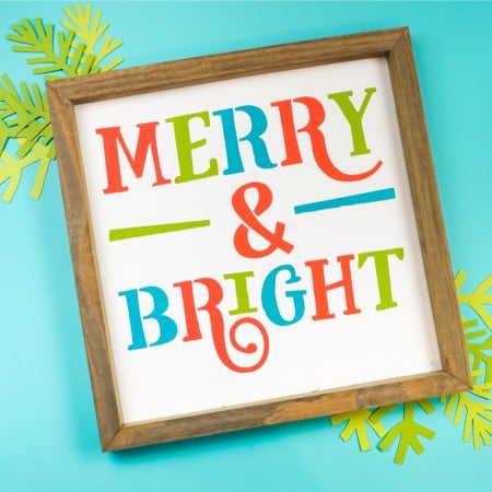 Merry and Bright image stenciled on a white sign.