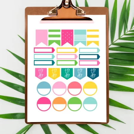 Clip board holding a page of planner stickers