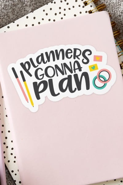 Notebook planner with a sticker on it that says "Planners Gonna Plan"