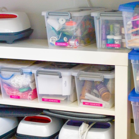 Plastic bins on shelves filled with crafting supplies