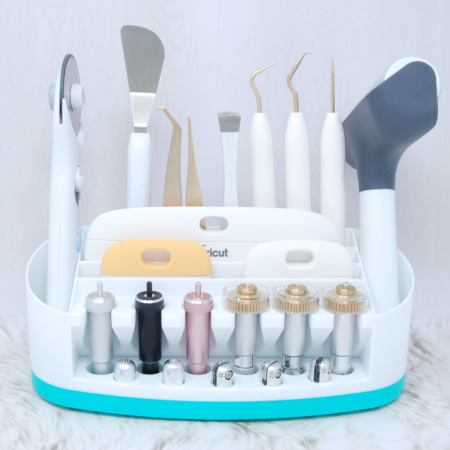 A turquoise and white Cricut tool holder