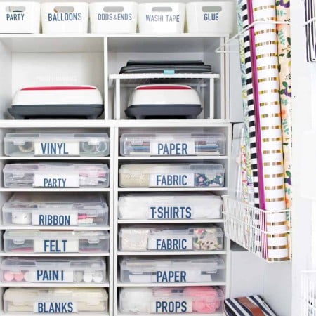 A closet filled with craft storage boxes