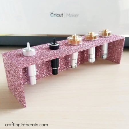 A tool blade holder made out of pink chipboard