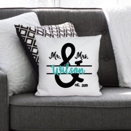 White pillow with a Mr. & Mrs. monogram on it with the last name