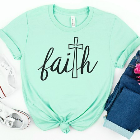 Mint green t-shirt with an image of a cross taking the place of the letter "T" in the word Faith