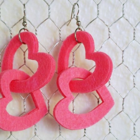 A pair of red felt heart earrings
