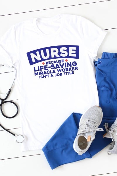 Stethoscope along with a white shirt with saying, "NURSE because life-saving miracle worker isn't a job title" and paired with blue scrub pants and tennis shoes.
