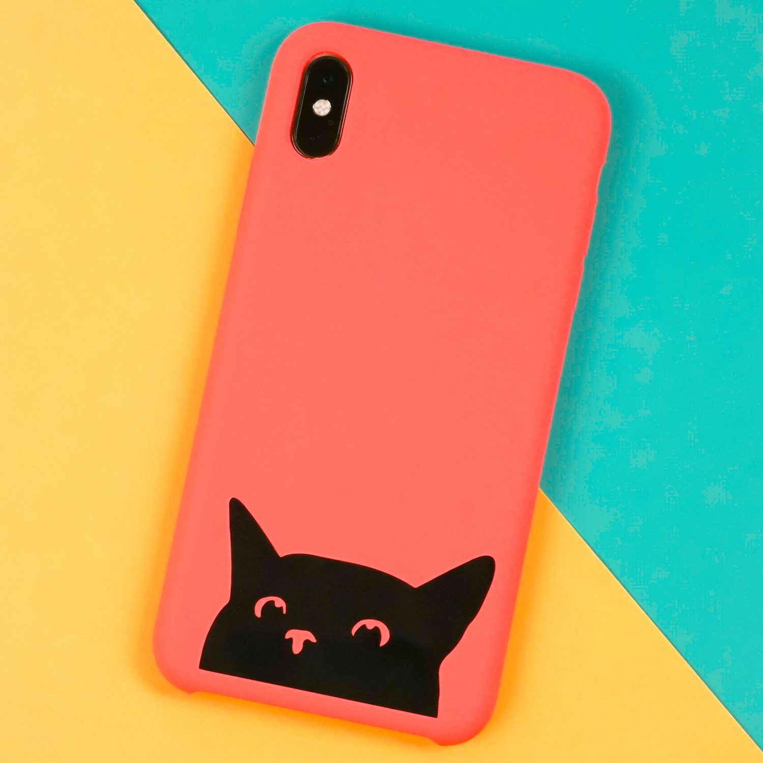 Cat phone case made with a Cricut on a yellow and teal background