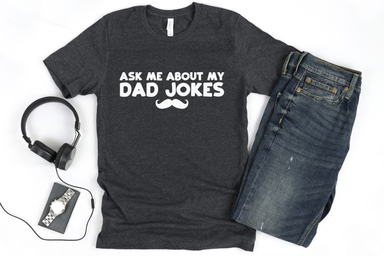 Custom t-shirt using funny father's day svg file "Ask me about my dad jokes" with headphones and jeans.