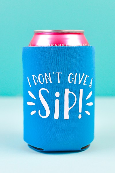 A canned beverage in a Koozie with a white vinyl design saying, "I Don't Give a Sip!"