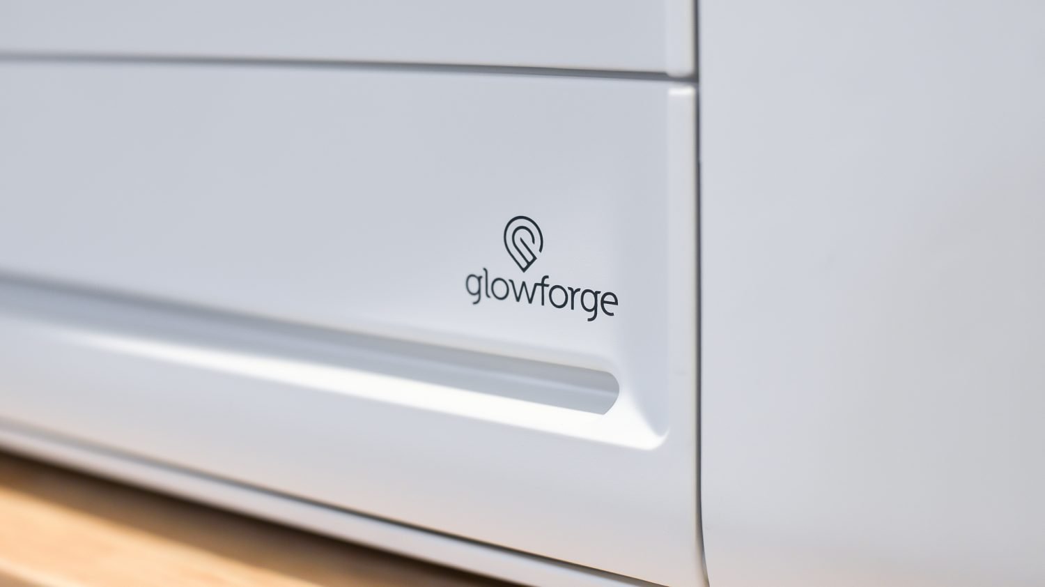 Closeup of Glowforge logo on machine.