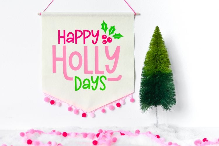 Close up image of the completed Happy Holly Days Christmas Banner near a small fake green tree