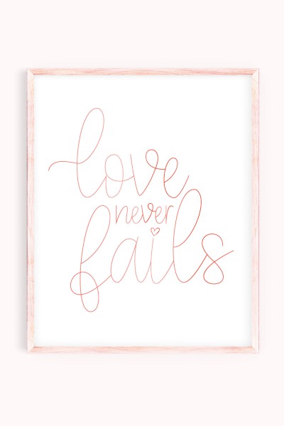 Love Never Fails artwork in pink frame