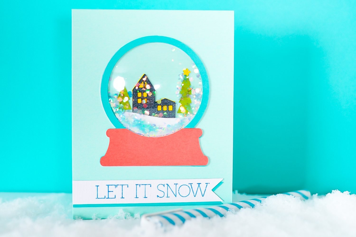 Finished snowglobe shaker card with fame snow and blue background.