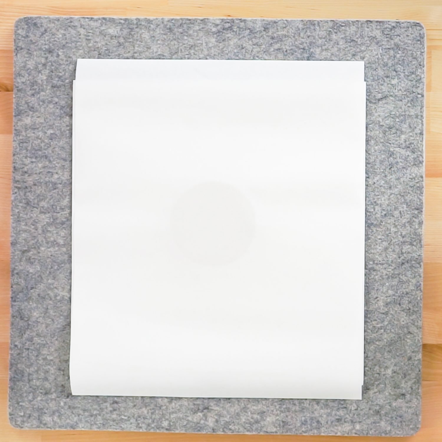 Image of a Cricut Mat with a piece of butcher paper on top of the mat