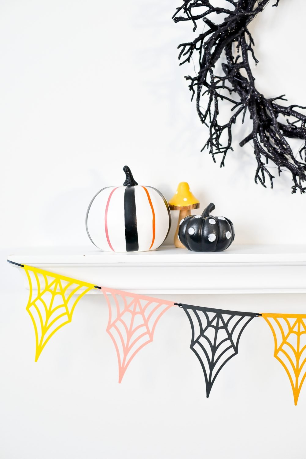 Close up of web banner hanging from shelf with Halloween pumpkins