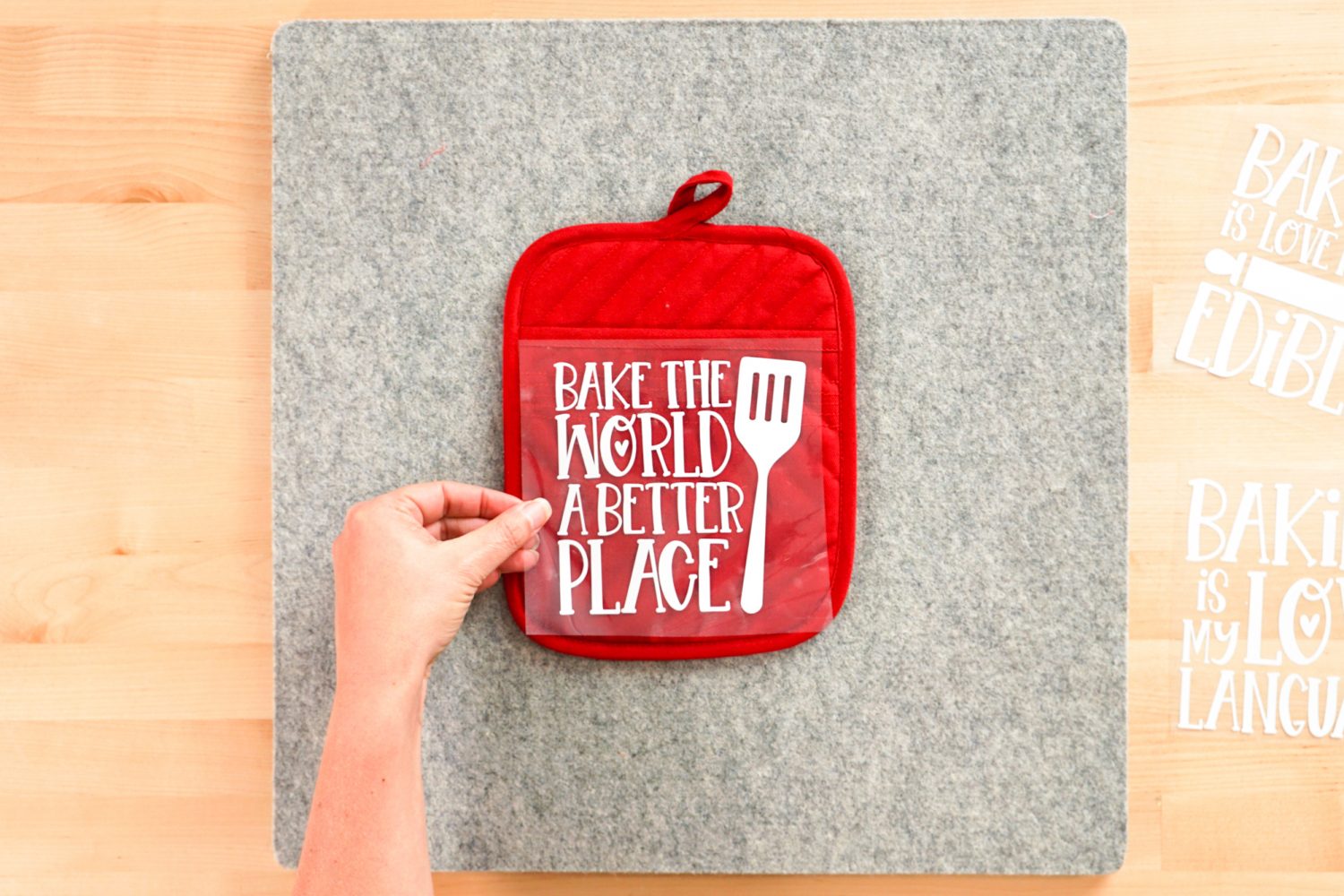 Hand placing decal on pot holder