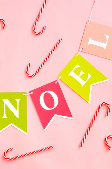 NOEL Banner on pink background with candy canes