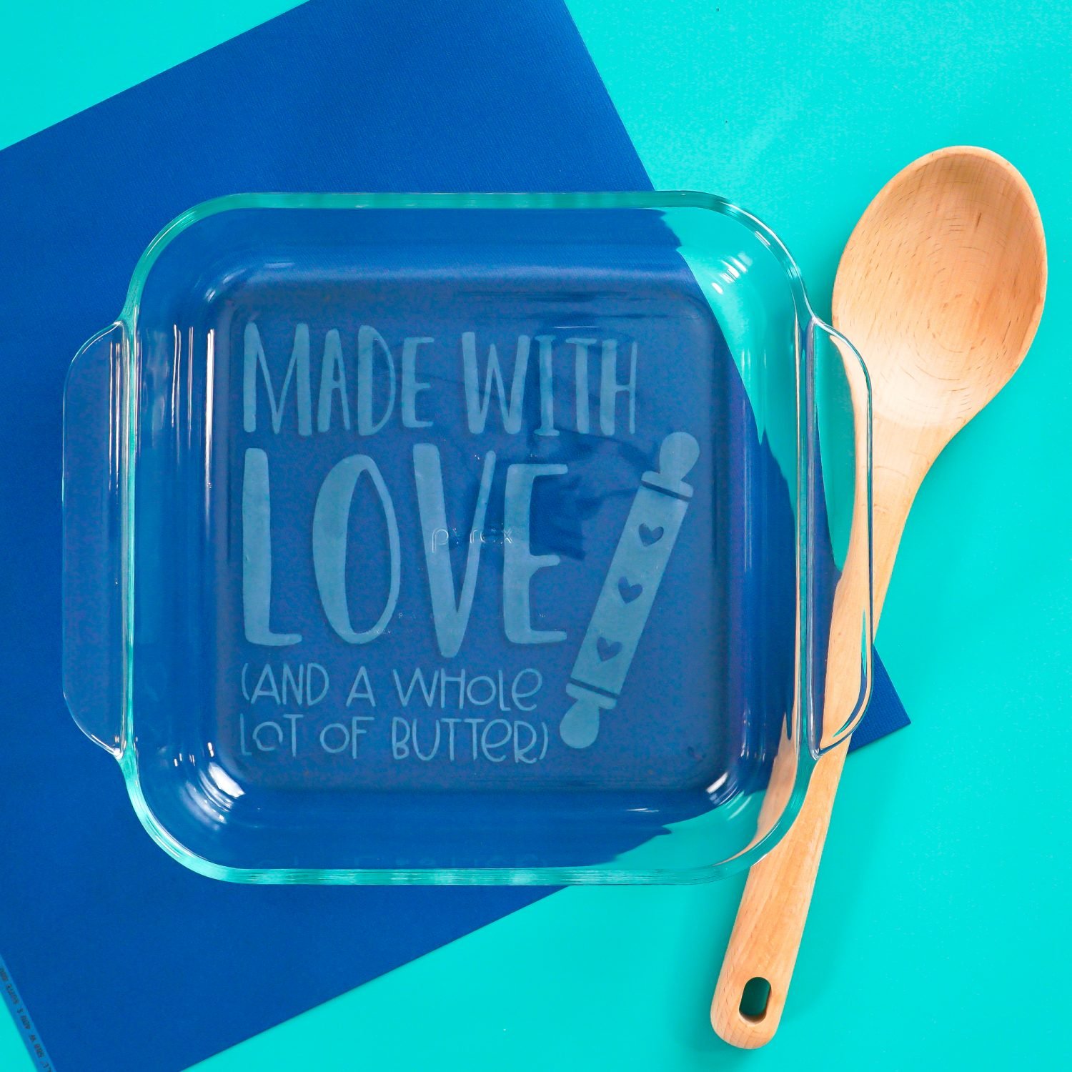 Finished baking dish on blue background with spoon.