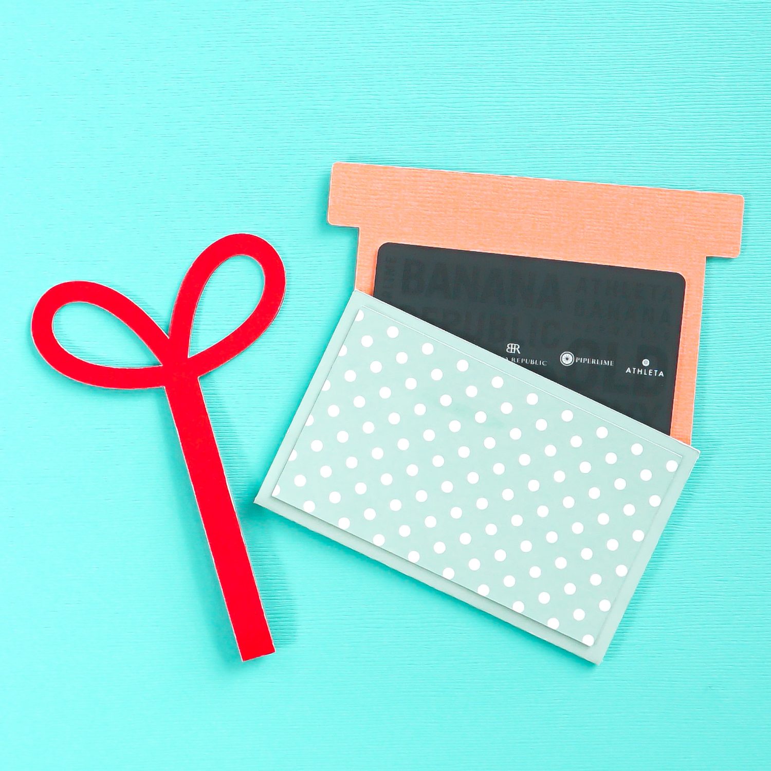 Finished gift card holder being opened on a blue background