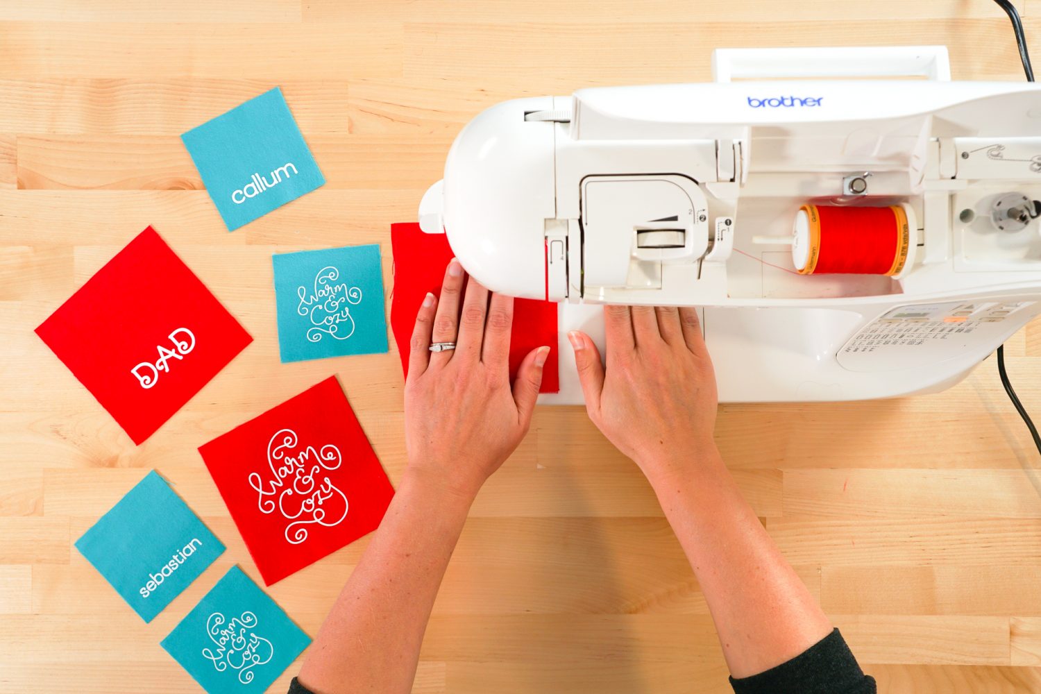 Hands sewing around the edge of the DIY hand warmer