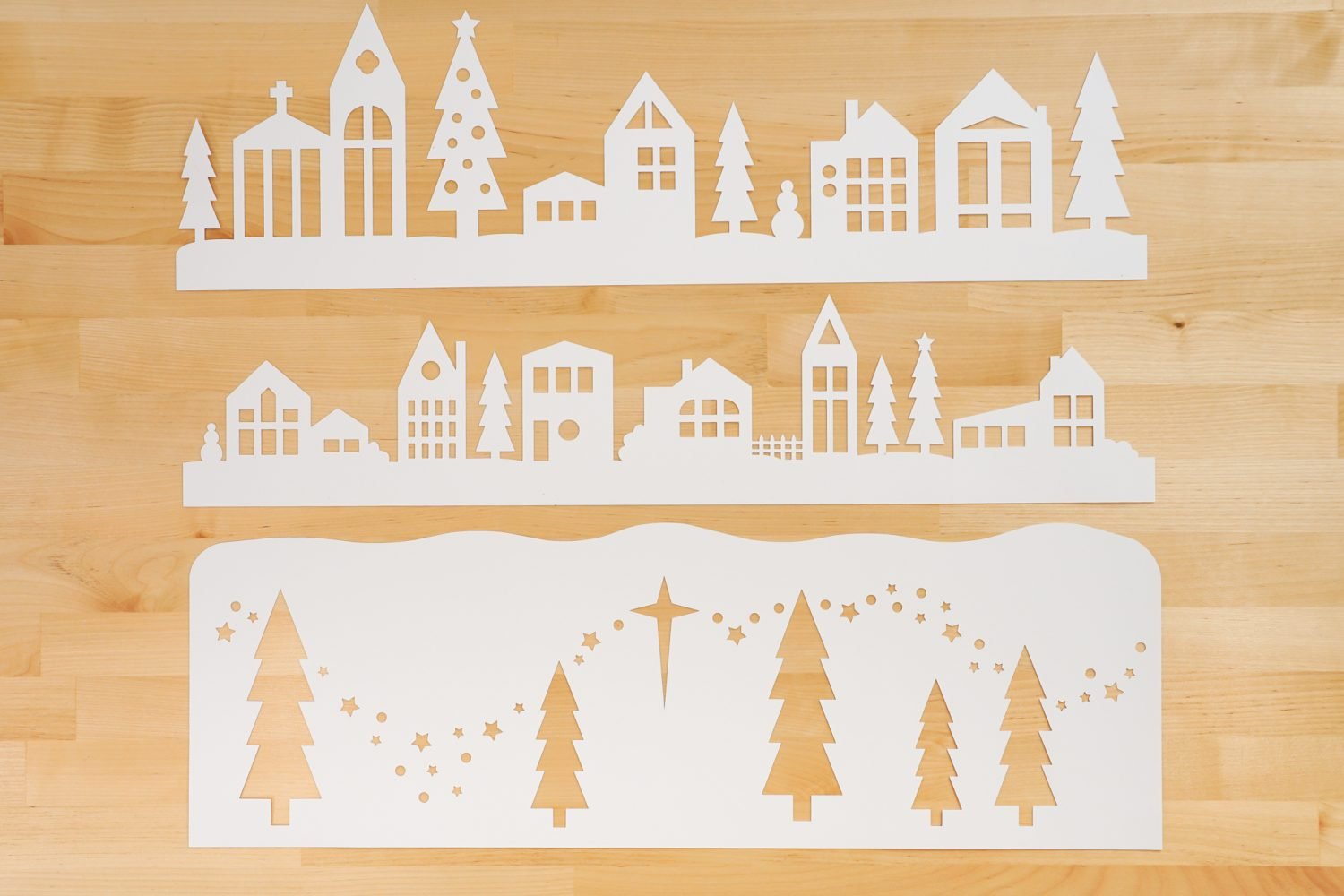 Three layers of the papercut Christmas village