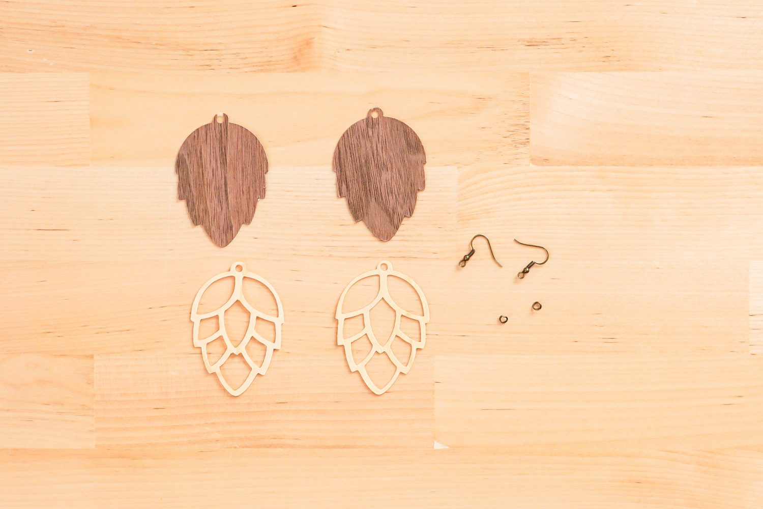 Veneer pinecones all cut and ready to assemble on a table.