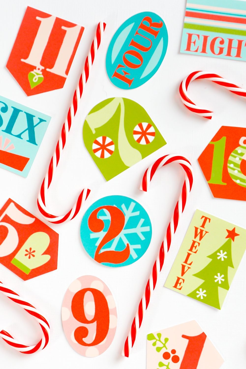 Finished 12 Days of Christmas gift tags staged with faux candy canes