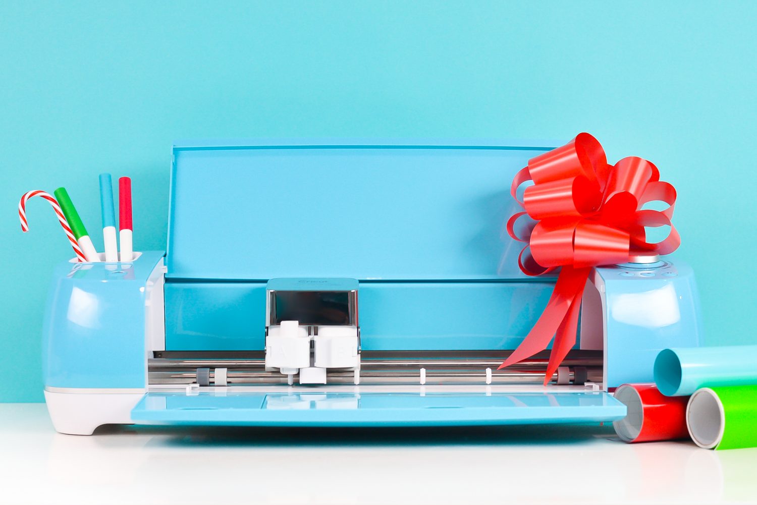 Cricut Explore "decorated" for Christmas with candy cane and bow plus matching materials