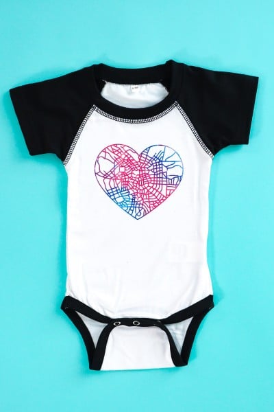 Cricut Infusible Ink bodysuit on teal background